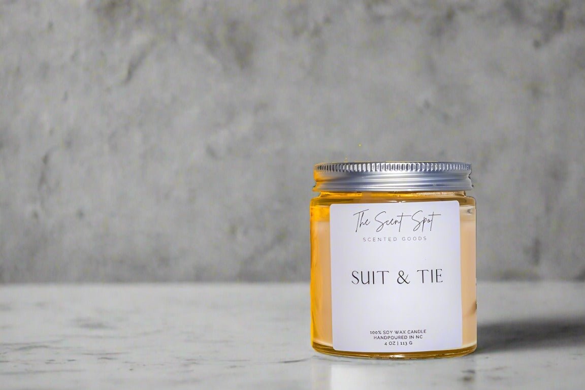 The Scent Spot Suit & Tie CandleCandleIlluminate your space with our soy wax candle, a captivating fusion of invigorating scents. At the top, experience the freshness of ozone and petitgrain, creating a Suit & Tie Candle